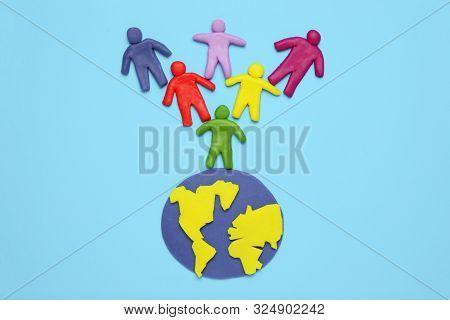 Multicolored Cartoon People On Globe. The Use And Depletion Of The Planet Earth, Overpopulation And 