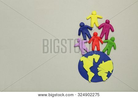 Multicolored Cartoon People On Globe. The Use And Depletion Of The Planet Earth, Overpopulation And 