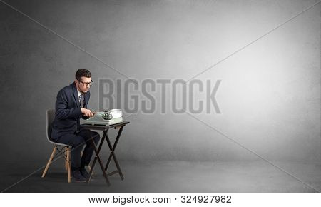 Man working hard on a typewriter in an empty space