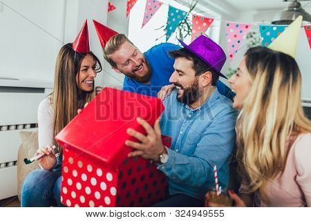 Young Group Of Happy Friends Celebrating Birthday At Home And Having Fun.