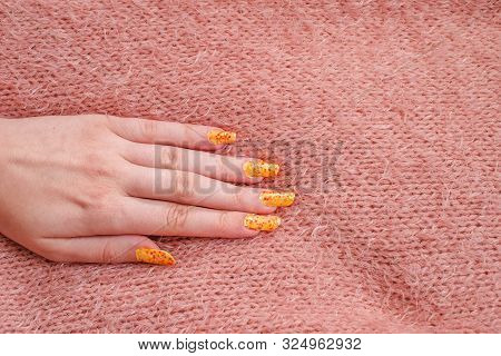 Girls Hand With Nailart On Sweater, Close View