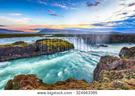 Fantastic Sunset Scene Of Powerful Godafoss Waterfall. Dramatic Sky Over Godafoss. Location: Bardard