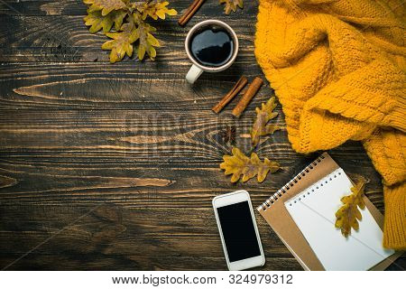 Autumn Flat Lay Background With Coffee, Notebook, Knitwear And Yellow Leaves. Creative Workplace Lay