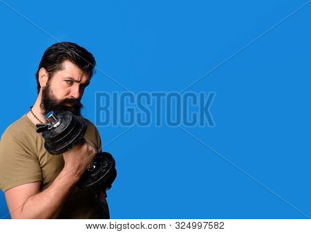 Healthy Sports Lifestyle, Fitness Concept. Handsome Man Lifting Dumbbell At Gym. Athletic Young Male