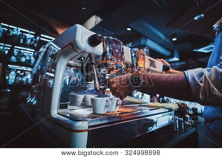 Talanted Barista Is Prepairing Coffee For Clients At Posh Restaurant Using Coffee Machine.