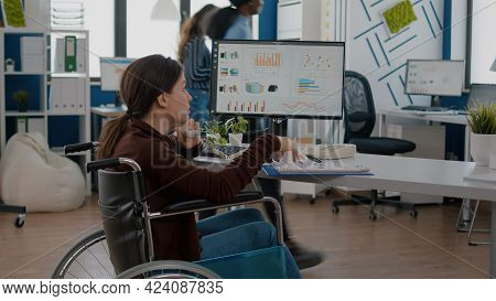 Busy Paralysed Handicapped Woman Worker Talking At Phone With Business Partner Sitting In Wheelchair