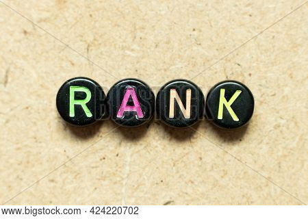 Black Color Round Alphabet Letter Block In Word Rank On Wood Background