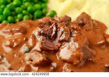 Slow Cooked Steak Diane Casserole With Mushroom. Mashed Potatoes And Green Peas