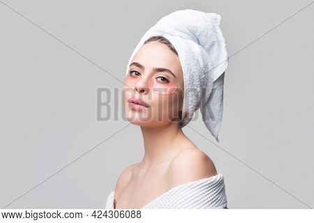 Woman Applying Eye Patches. Close Up Portrait Girl With Towel On Head. Portrait Of Beauty Woman With