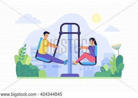 People Swing Feets On Street Trainer. Young Man And Woman Actively Warming Up On Fitness Equipment. 