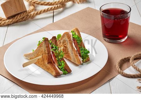 Toasted Bread Sandwiches With Ham, Cheese, Tomatoes, Lettuce And Compote
