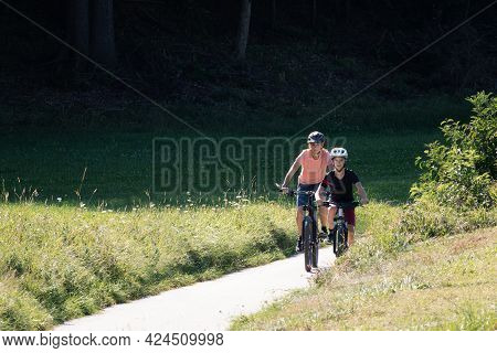 Two Girls On Mtb Bikes. Mother And Daughter Riding On A Forest Trail.