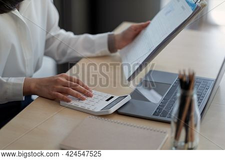 Close Up A Woman Working About Financial With Calculator At Her Office To Calculate Expenses, Fianci