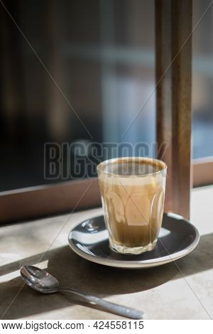 A Glass Of Coffee At Cafe Corner With A Perfect Shade.