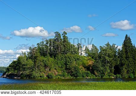 White Turrets Of The Chapel In Ludwigsburg Park Mon Repos In Vyborg On The Background Of Blue Sky.