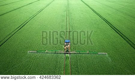 Application Of Water-soluble Fertilizers, Pesticides Or Herbicides In The Field. View From The Drone