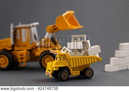 Yellow Dump Truck, Excavator, Building Materials. Cargo Track, Aerated Concrete Blocks. Delivery Bui