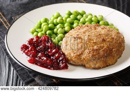 Rich And Delicious Swedish Veal Patties Wallenbergare With Boiled Green Peas Closeup In The Plate On