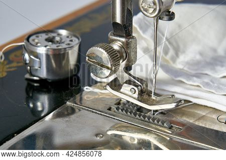 Set Of Needles And Threads For A Sewing Machine On A Dark Background.