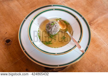 Leberknoedelsuppe, An Austrian Liver Dumpling Soup, A Beef Broth With Chives With Spoon