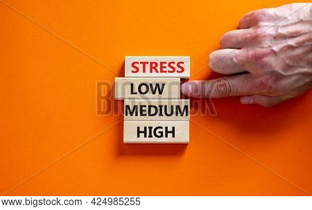 Low Or High Stress Level Symbol. Businessman Chooses The Wooden Block With Words Low Stress. Words S