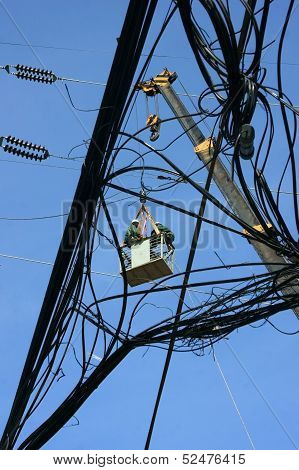 Electrician as spider between electric wire network