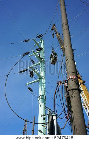 Electrician as spider between electric wire network