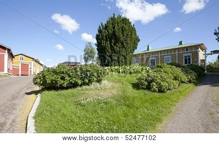 Flowers and elderly wooden buildings.