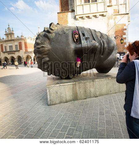 KRAKOW, POLAND - FEB 28, 2014: Igor Mitoraj's sculpture Eros Bendato (Eros Tied) 1999 on main square of the city. This worth about half a million euros bronze sculpture was donated to Krakow for free.