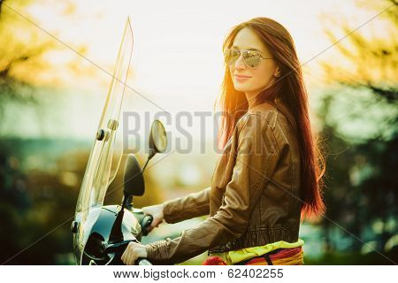 Young beautiful woman on motorcycle