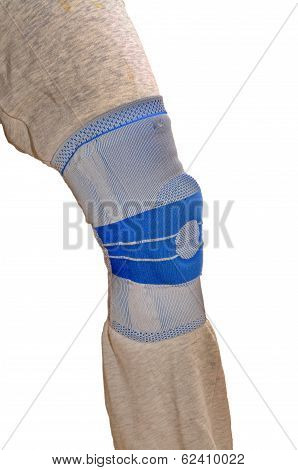 Sports Knee Brace - A Stabilizing Silicone Blue And Gray Medical Sports Knee Brace Worn Over Sweatpa