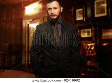 Handsome well-dressed man with beard in jacket and tie