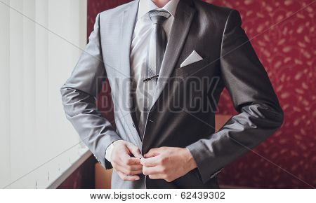 groom getting ready in suit