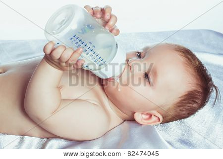 Lovely little girl with blue eyes lying in diapers