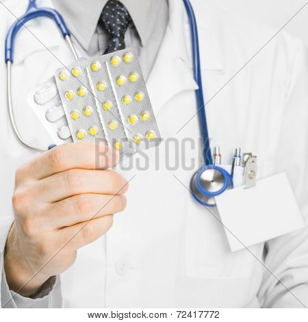 Doctor Holdling Pills In His Hand