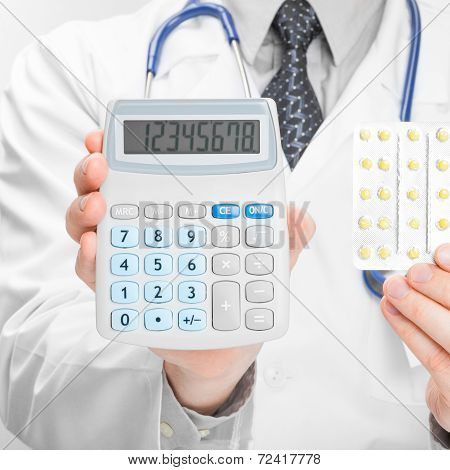 Doctor Holdling Calculator And Pills In His Hands - Heath Care Concept