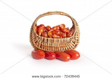 Red tomatoes in a basket isolated on vhite background