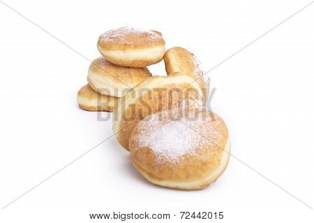 Donuts topped with powdered sugar on a white