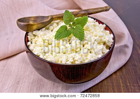 Curd In Wooden Bowl With Spoon And Mint On Napkin