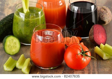 Glasses With Fresh Organic Vegetable Juices On Wooden Table