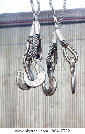 Iron Industrial Hooks On A Ropes In Warehouse. Indoors Close-up.