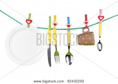 Tableware dried on rope isolated on white