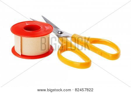 Roll of Medical Sticking Plaster and cutting scissors on White Background