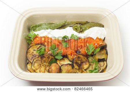 Fried aubergine (or eggplant) and fried mild green peppers served with garlic infused tomato and yogurt sauces. This is a traditional Turkish summer dish, served cold.