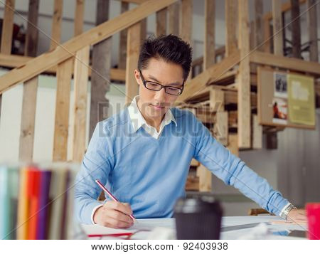 Young chineese engineer working in office