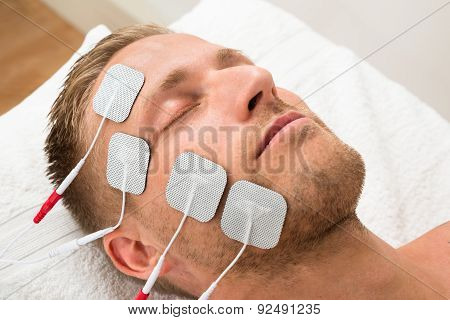 Man Closing Eyes With Electrodes On Face