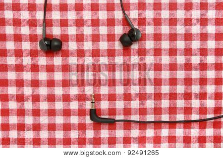 Headphones On A red tablecloth.