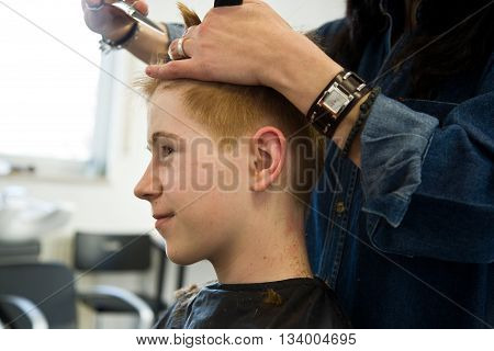 Smiling Young Boy With Red Hair At The Hairdresser