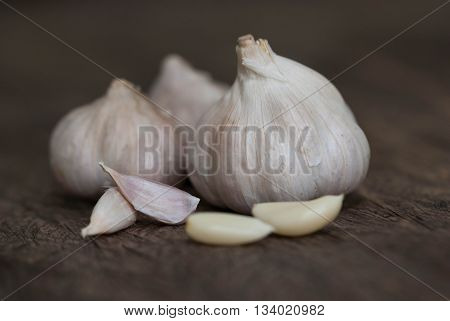 Garlic.Close up of garlic bulb and cloves on wooden surface.