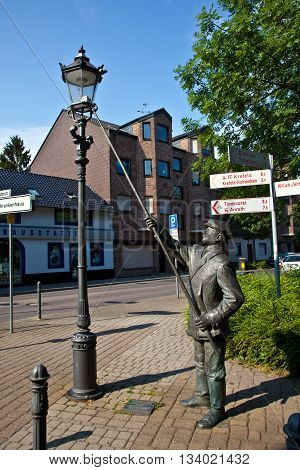 WILLICH, GERMANY - JUNE 3, 2014: statue for the historic figure of the lateerepit the man who lights up the laterns in the evening in former times